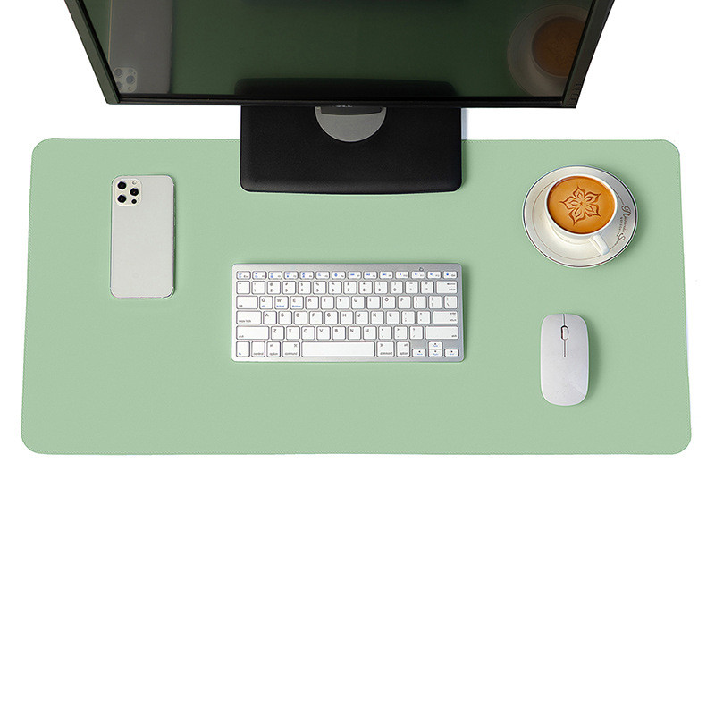 Minimalist green vegan leather desk mat on a modern wooden desk setup