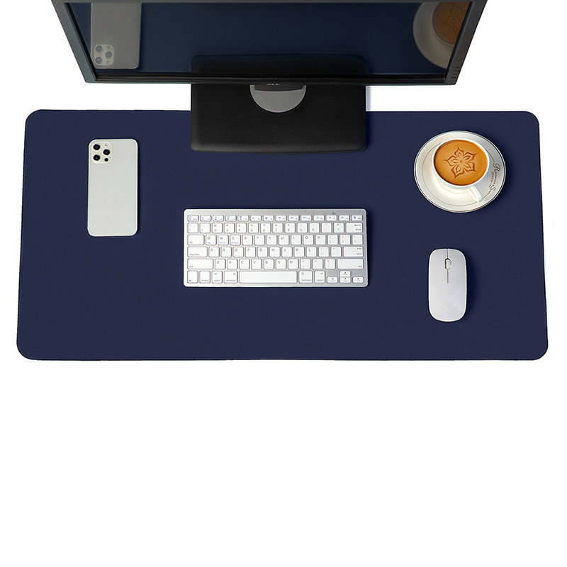 Minimalist navy blue vegan leather desk mat on a modern wooden desk setup