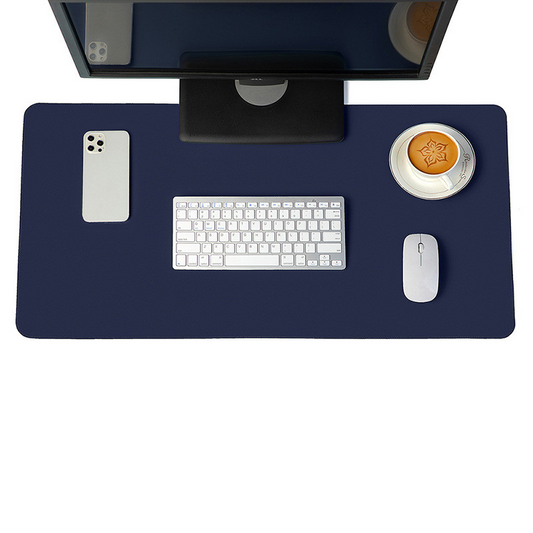 Minimalist navy blue vegan leather desk mat on a modern wooden desk setup