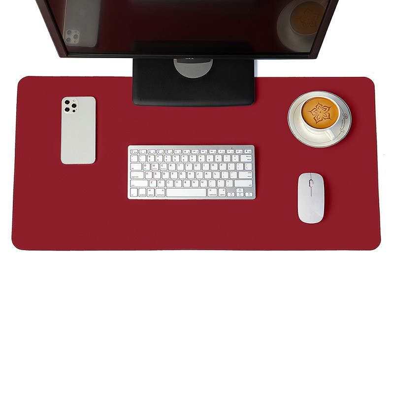 Minimalist red vegan leather desk mat on a modern wooden desk setup