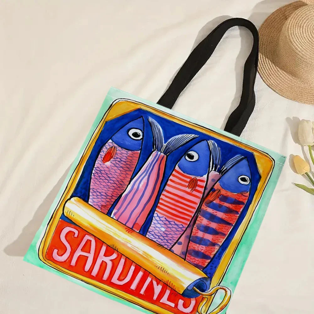 Colourful tote bag with fish design and 'SARDINES' text on a beige background