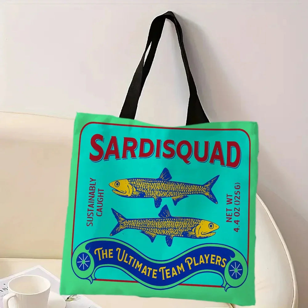 Tote bag in bright green and turquoise with 'Sardisquad' design featuring fish illustrations on a light background